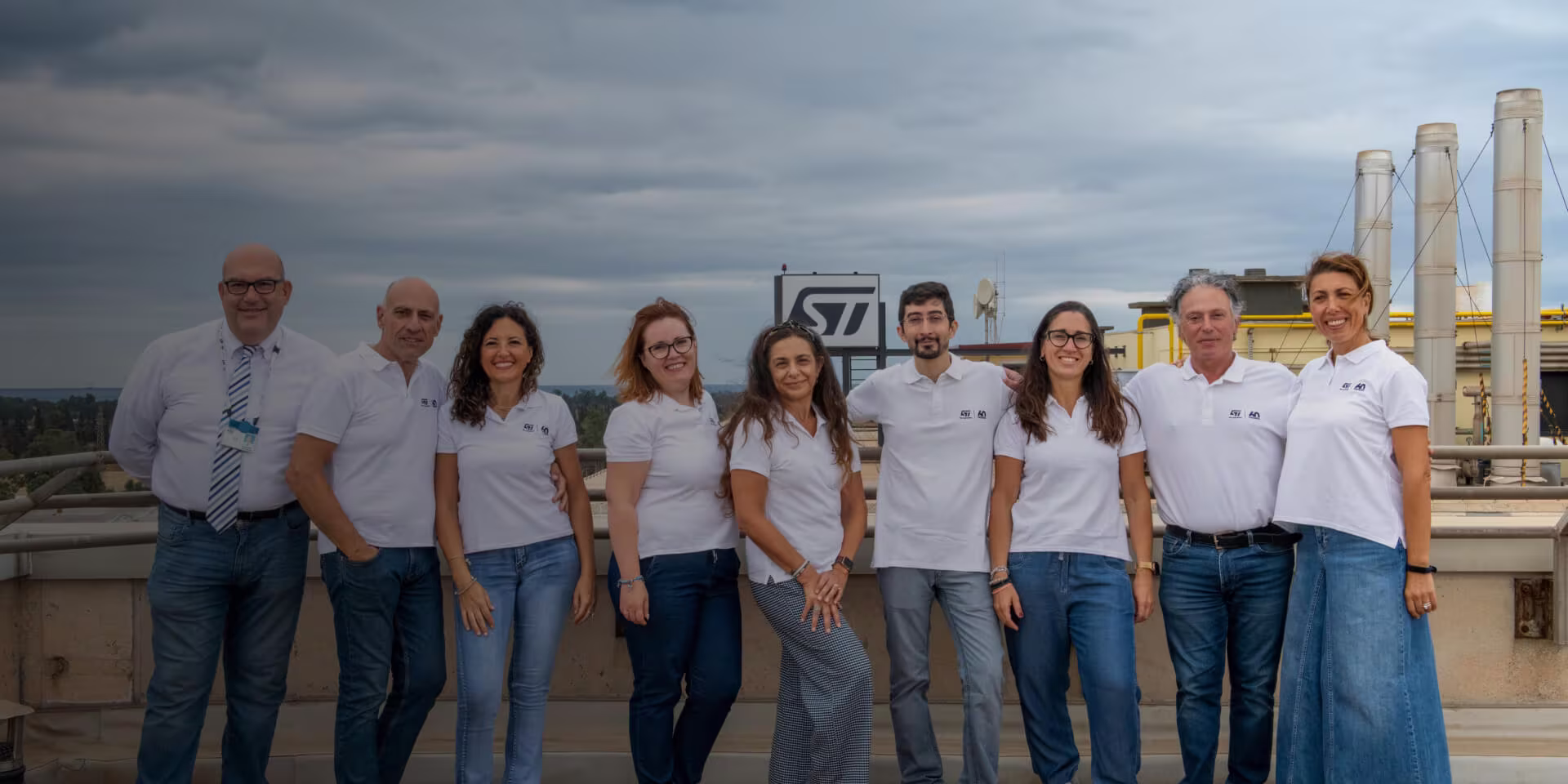 Group of ST volunteers on a rooft top of ST faciltity