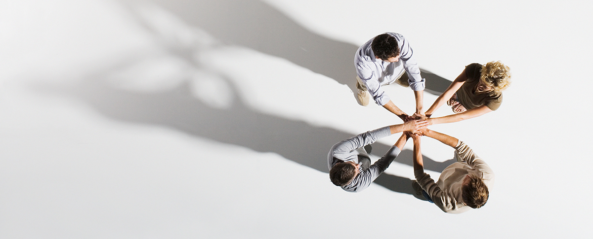 Group of people in circle doing a flower with their hands