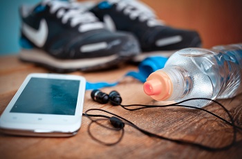 Shoes close to a mobile and water of bottle