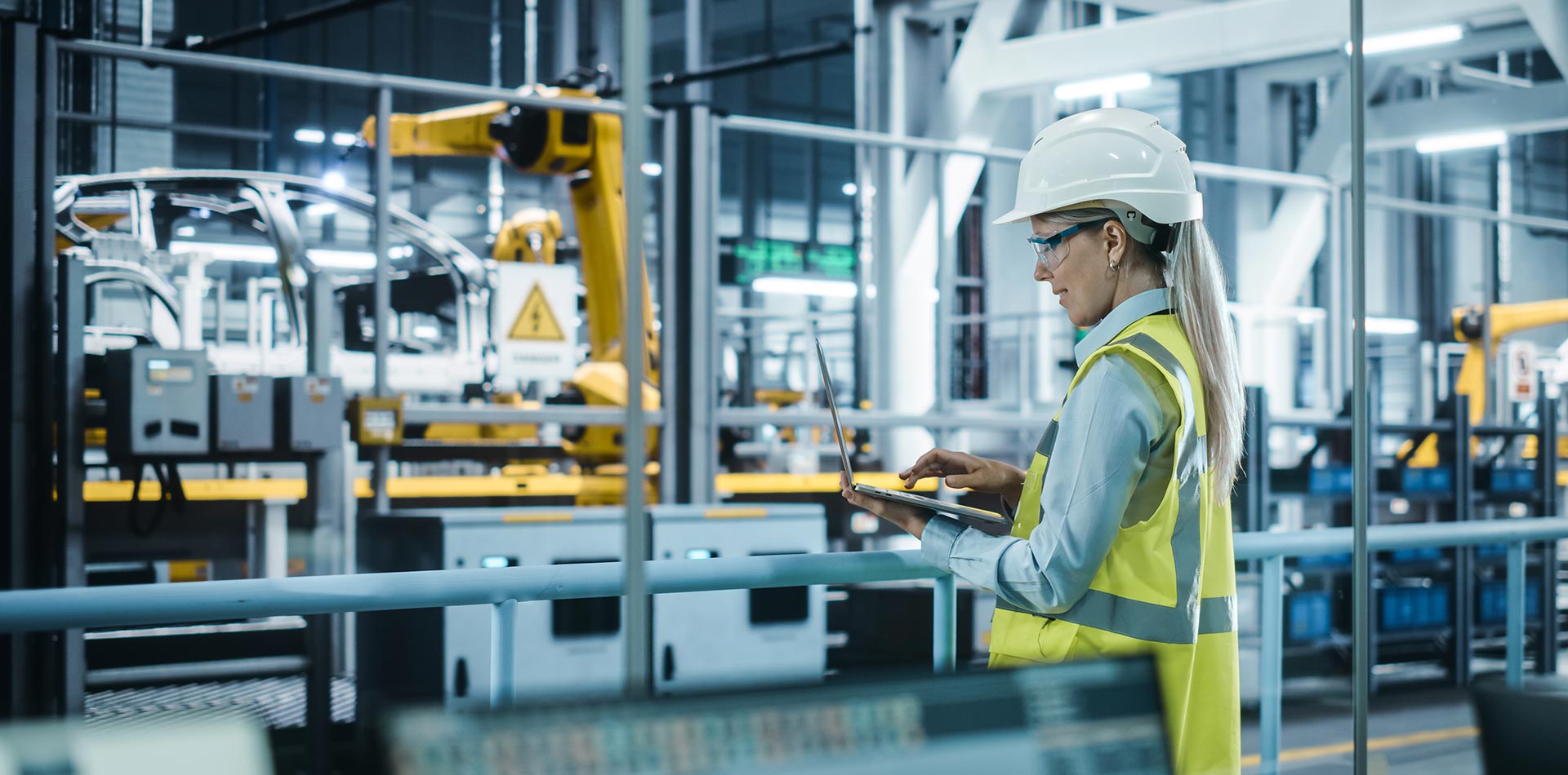 A woman technician working on a computer in a fab